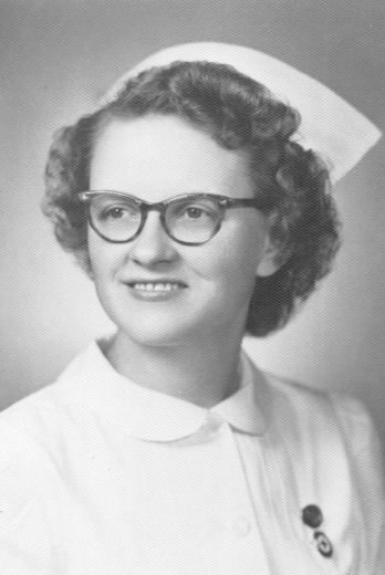 Black and white photo - Alice Johnson wears a nursing uniform with a pin.