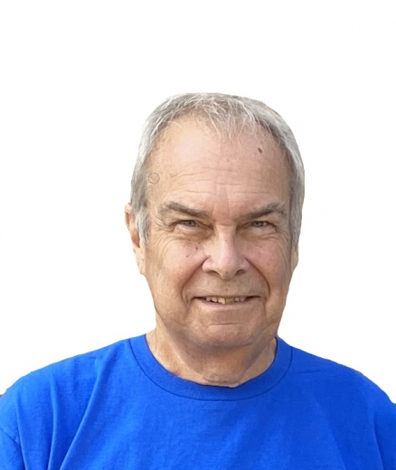 A cutout photo of Robert. He smiles widely and wears a blue t-shirt.